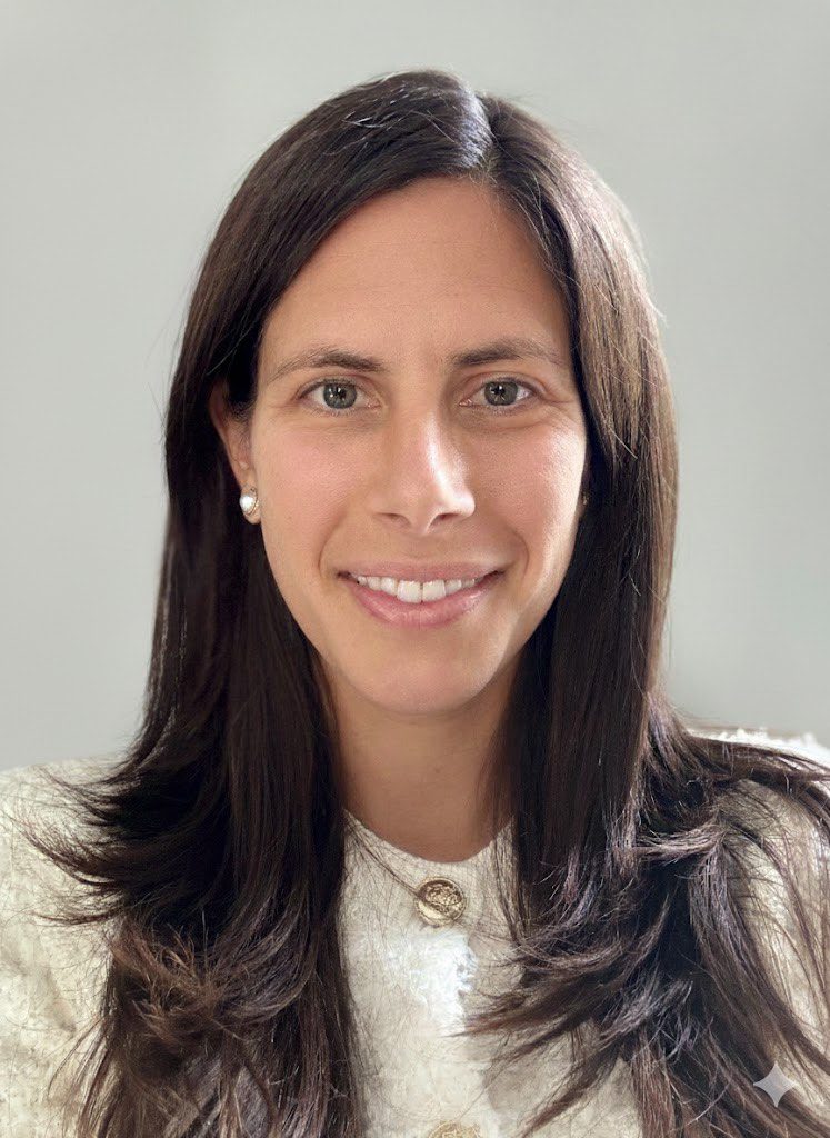 Portrait of a woman with long dark hair and a warm smile.